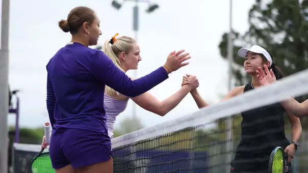 Jermine Sherif and Reece Carter shake hands with their opponents from Wisconsin after doubles