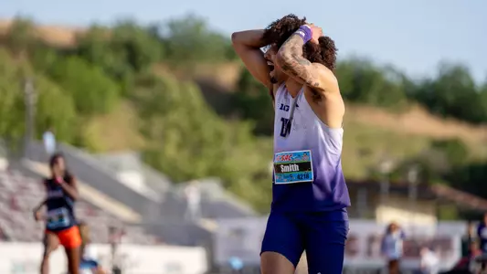 Trevontay Smith celebrates a mark with his hands on his head at the Mt. SAC Relays