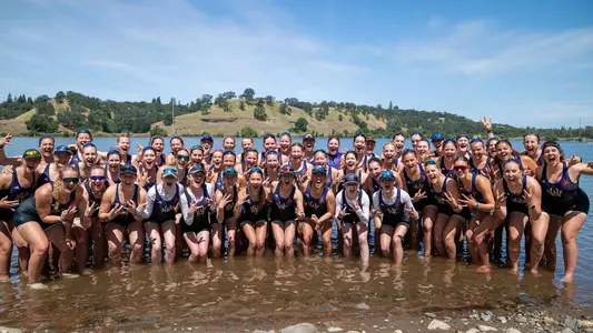 UW women's rowing team photo on the beach at Lake Natoma after the 2026 B1G Invitational