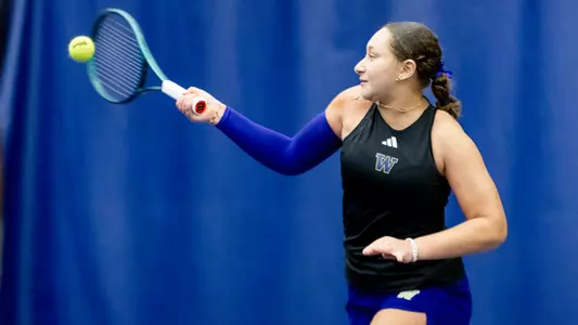 Jermine Sherif hits the tennis ball with a raquet