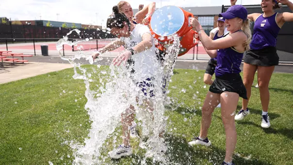 Head coach Robin Stephenson gets dumped with water by Reece Carter and Zehra Suko following a 4-1 win over Penn State at the Big Ten Tournament