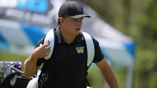 Emil Herstad carries his clubs during Round One of the Big Ten Championships