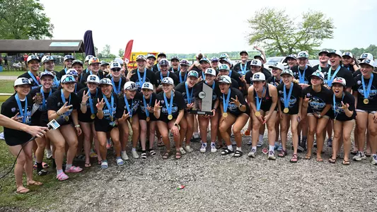 The Washington womens' rowing team poses for a photo celebrating the 2026 Big Ten women's rowing championship