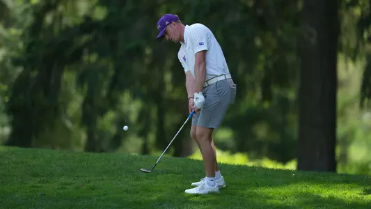 Finn Koelle chips the ball out of the green-side rough on the second day of the Big Ten Championships