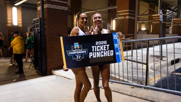 Julia David-Smith and Chloe Thomas pose with a Ticket Punched sign at NCAA Prelims
