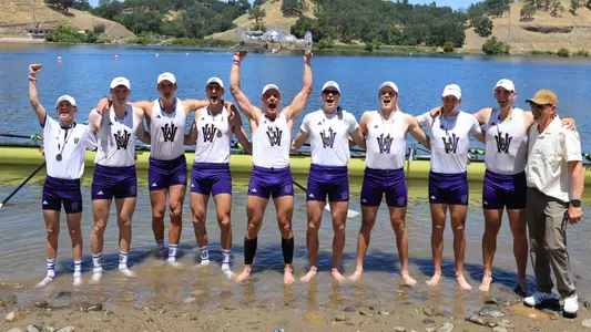 The UW men's varsity eight celebrates with the trophy after winning the 2026 national championships