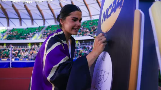 Sofia Cosculluela signing her name after winning the 2026 NCAA heptathlon