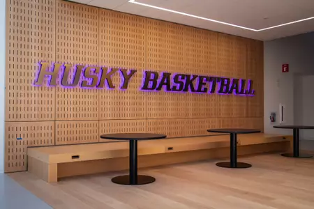 Husky Basketball purple letters on wall