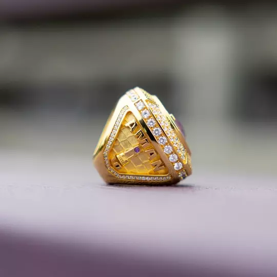 UW men's soccer national championship ring with "Aman" and NCAA trophy on the side