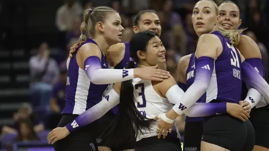 Kaitlyn Nguyen smiling in the Husky huddle