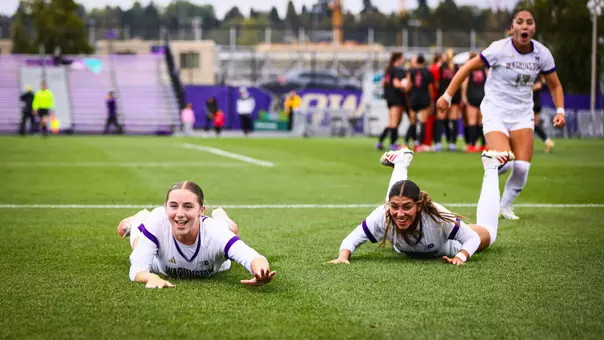 Jadyn Holdenried and Andrea Leyva slide towards the corner flag in UW's 1-0 win over Rutgers