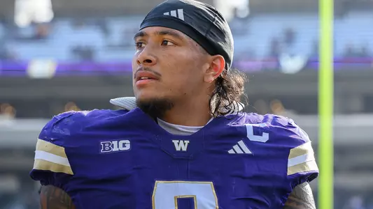 Jacob Manu stands on the sideline against Eastern Washington