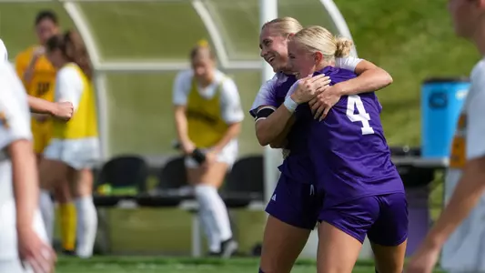Brynlee Meyerhoffer and Bella Sackett celebrate a goal against Idaho in 2025