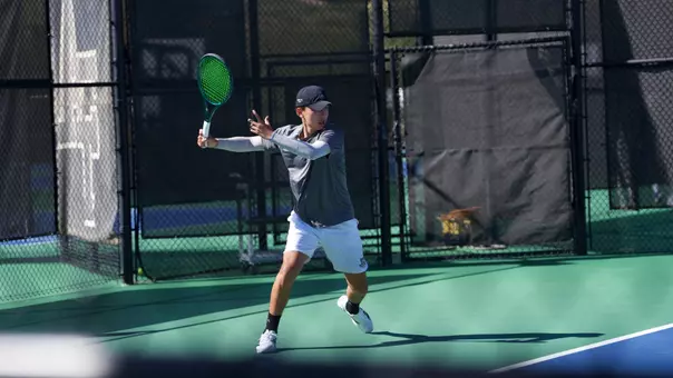 Ken Dinh returns a serve at the Bedford Cup