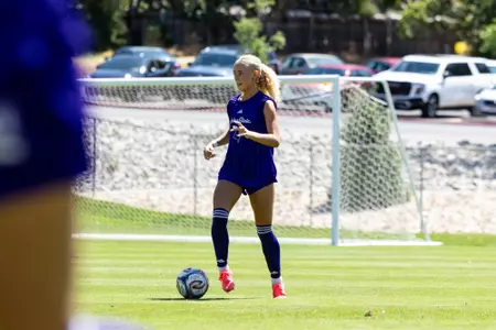 Wildcat soccer player dribbling ball