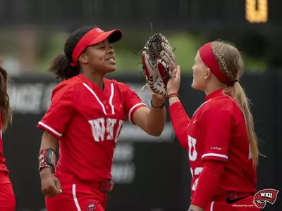WKU Hilltoppers catcher/outfielder Jessica Bush (22) and outfielder Taylor Davis (6) plays during a game against the MT Blue Raiders on May 7, 2022 at WKU Softball Complex in Bowling Green, KY