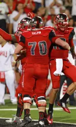 Offensive linemen celebrate a touchdown.