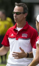 Head coach Jason Neidell gives instruction to No. 2 Hannah Chua