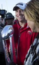 Jeff Brohm holding the 2015 C-USA Championship trophy