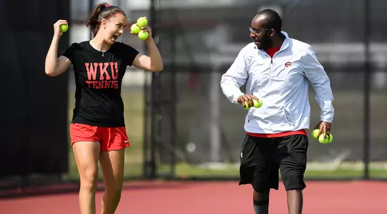 WKU tennis coach Jonatan Berhane tennis balls