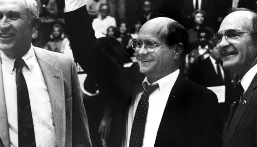 Wes Strader (center) receives a commemorative game ball in celebration of 25 years from John Oldham and Jimmy Feix.