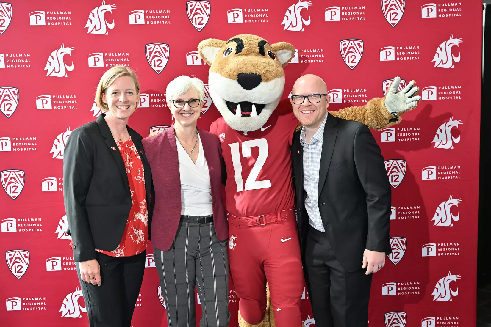 Sofie Aagaard (left) and husband Christian (right) takes a photo with Butch T. Cougar and Chancellor Elizabeth Chilton in the middle