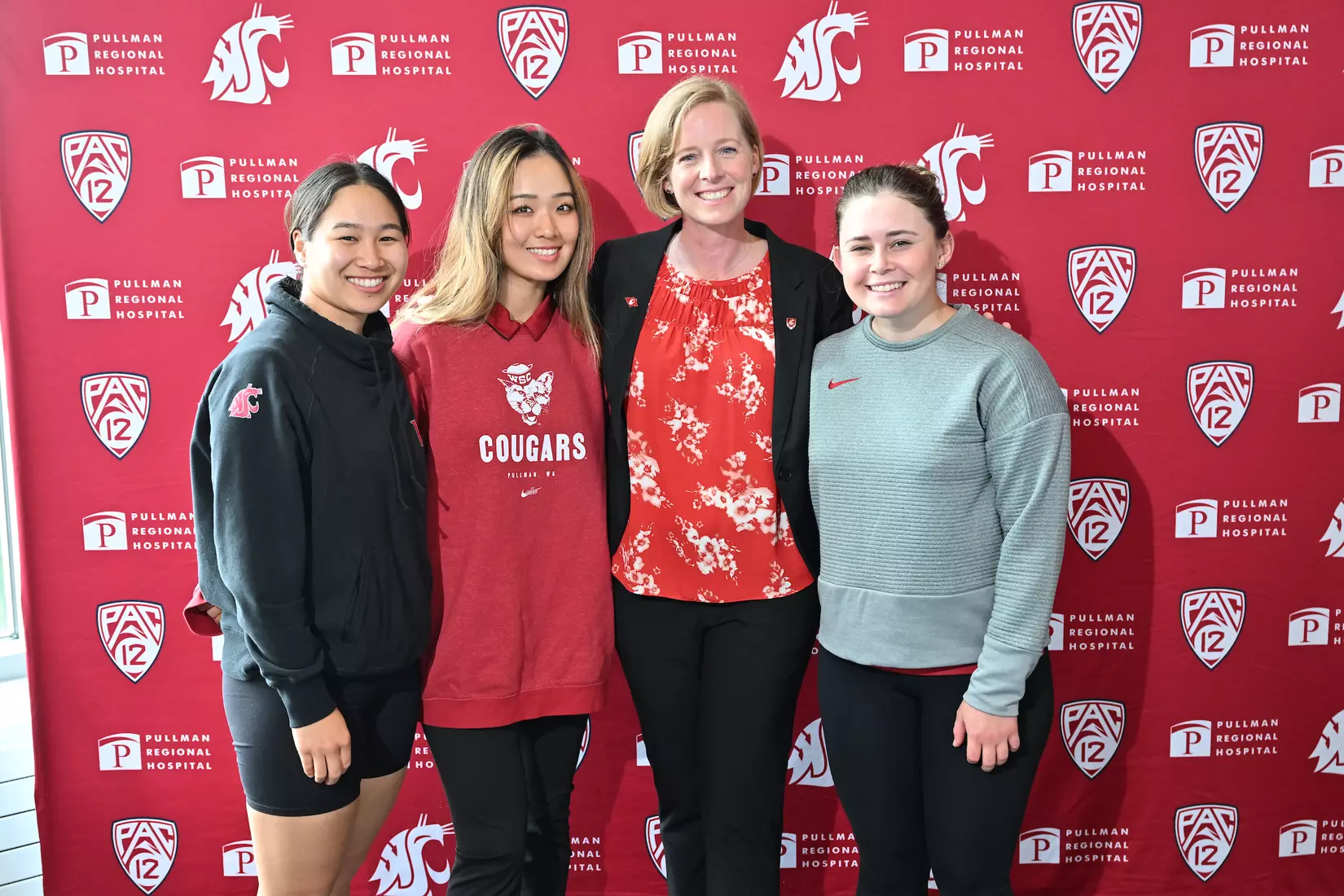 Sofie Aagaard takes a photo with three of her women's golf student-athletes