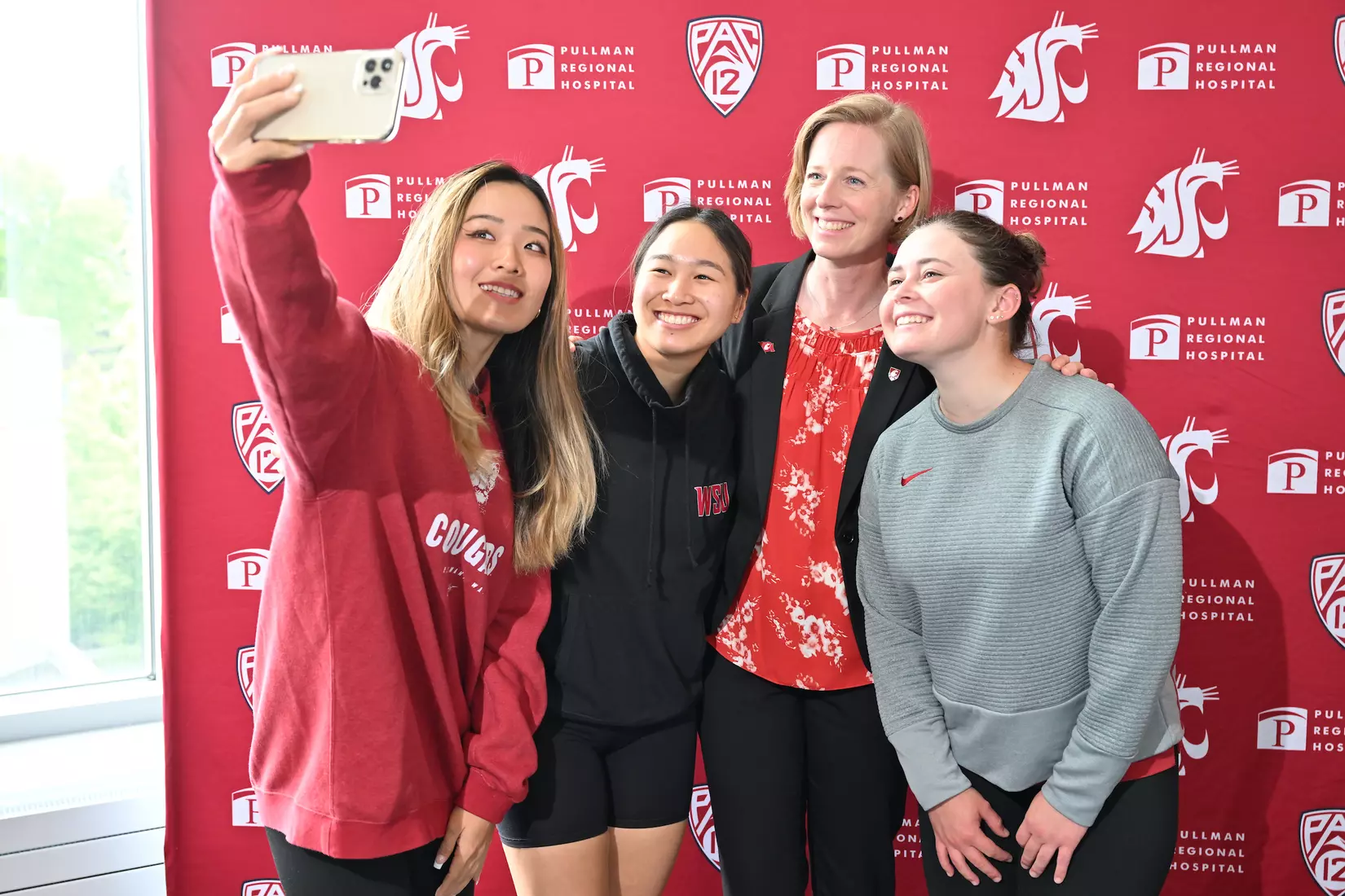Sofie Aagaard takes a selfie with three of her women's golf student-athletes