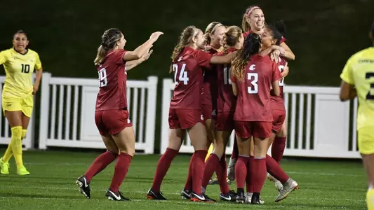 Soccer Team celebrates a goal against Oregon