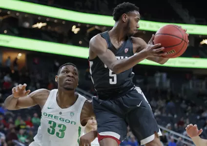 Washington State's Marvin Cannon grabs a rebound over Oregon's Francis Okoro during the first half of an NCAA college basketball game in the first round of the Pac-12 men's tournament Wednesday, March 13, 2019, in Las Vegas. (AP Photo/John Locher)