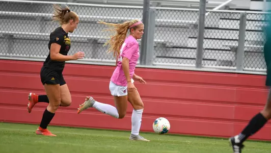 Brianna Alger in her pink uniform against ASU