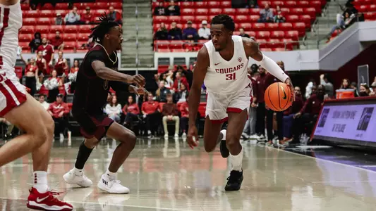 Kymany Houinsou looks to drive against a Texas State defender