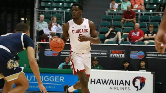 TJ Bamba brings the ball up the court against George Washington