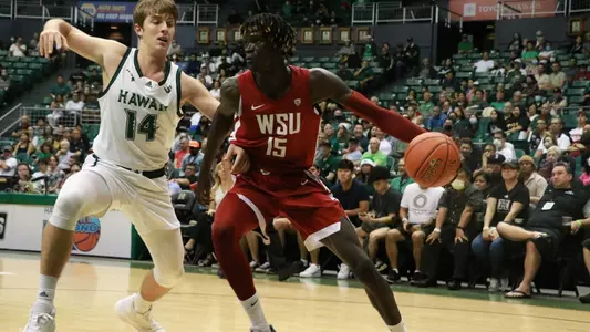 Adrame Diongue drives baseline on his Hawai'i defender