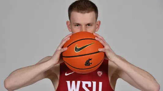 Justin Powell holds the ball in front of his face during a photo shoot