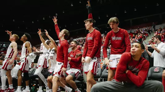 The Cougar bench reacts to made shot against Stanford
