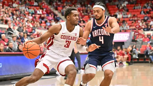 Kymany Houinsou drives on an Arizona defender