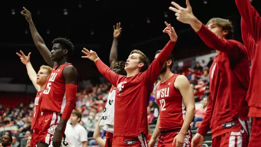 The Cougar bench celebrates a made 3-pointer against Detroit Mercy