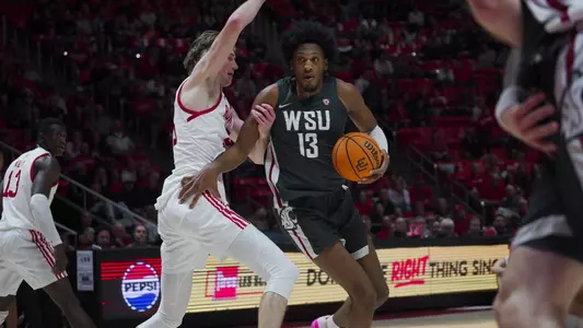 Isaac Jones drives against a Utah defender, Dec. 29, 2023 from the Huntsman Center