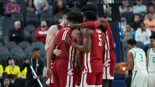 The Cougs huddle during a break in play against Oregon