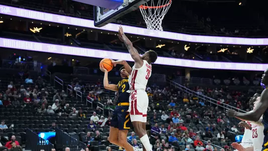 Kymany Houinsou rises for a block against California
