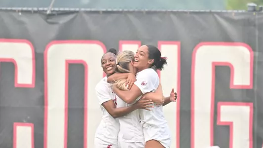 Margie Detrizio, Grayson Lynch, and Khalia Gathright celebrate