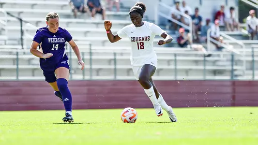 Nat Lewis dribbles by a Weber State defender