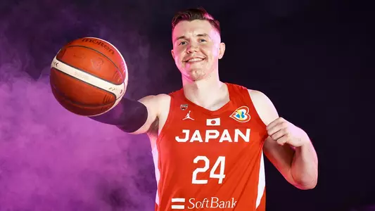 Josh Hawkinson poses in his Team Japan jersey