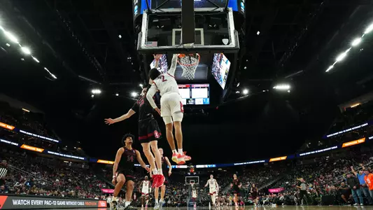 Myles Rice dunks over a Stanford defender, March 14, 2024