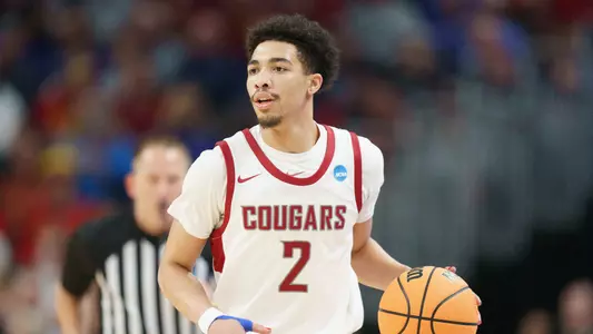 Myles Rice brings the ball up the court against Drake, March 21, 2024