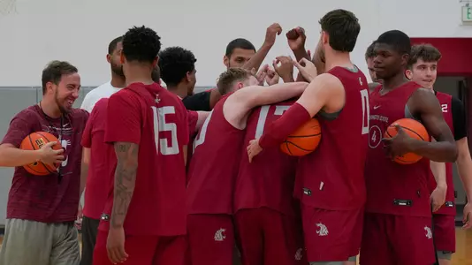 Men's basketball huddles during a summer training session