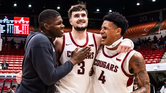 Cedric Coward, Ethan Price, and LeJuan Watts celebrate after the win over Pepperdine, Feb. 8, 2025