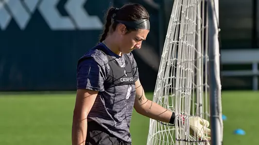 Keara Fitzgerald collects soccer balls during a training