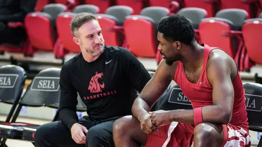 George Galanopoulos talks with ND Okafor before a game